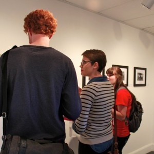 Students carefully study the contents of the gallery